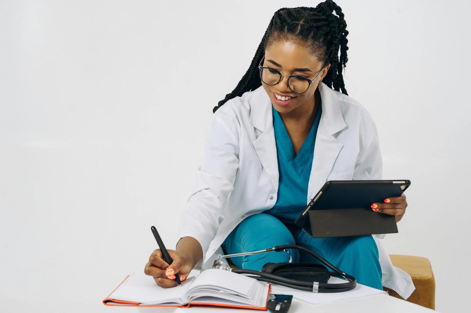 Provider reviewing notes with a tablet